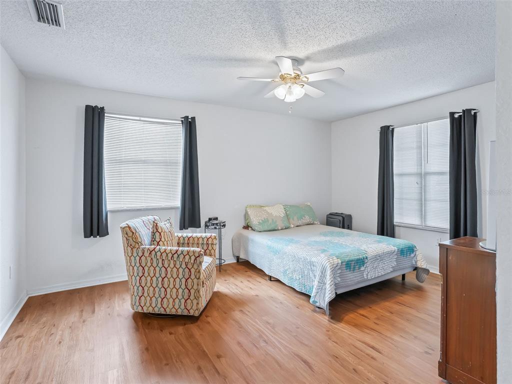 8850 Southwest 116th Place Road Ocala, FL 34481 - Photo 20 of 53 a bedroom with a bed and wooden floor