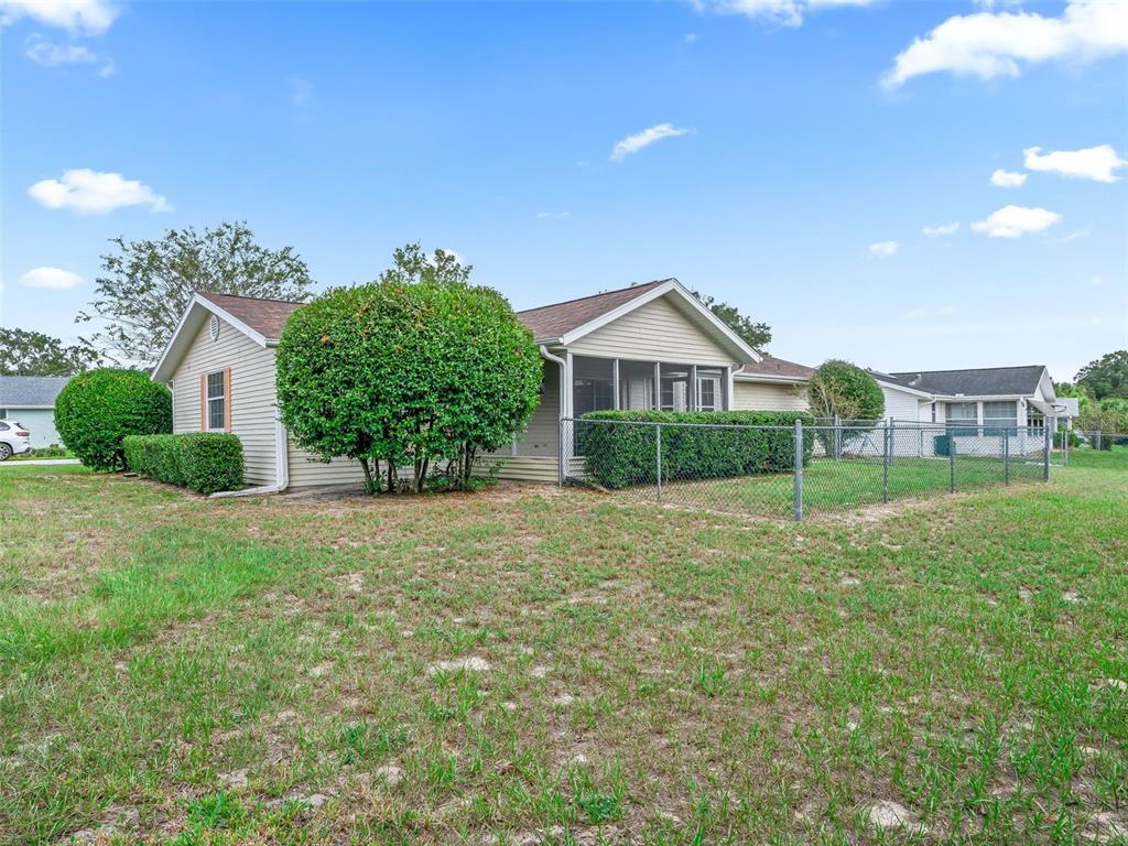 8850 Southwest 116th Place Road Ocala, FL 34481 - Photo 30 of 53 a view of a big house with a big yard and potted plants