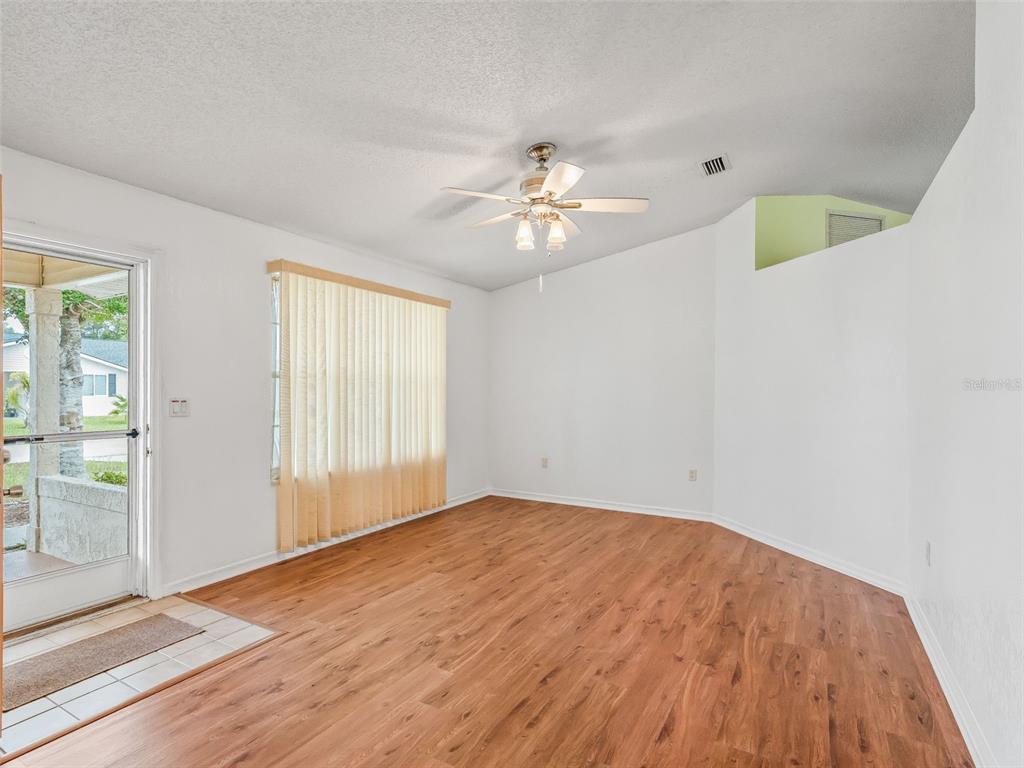 8850 Southwest 116th Place Road Ocala, FL 34481 - Photo 9 of 53 wooden floor in an empty room with a window