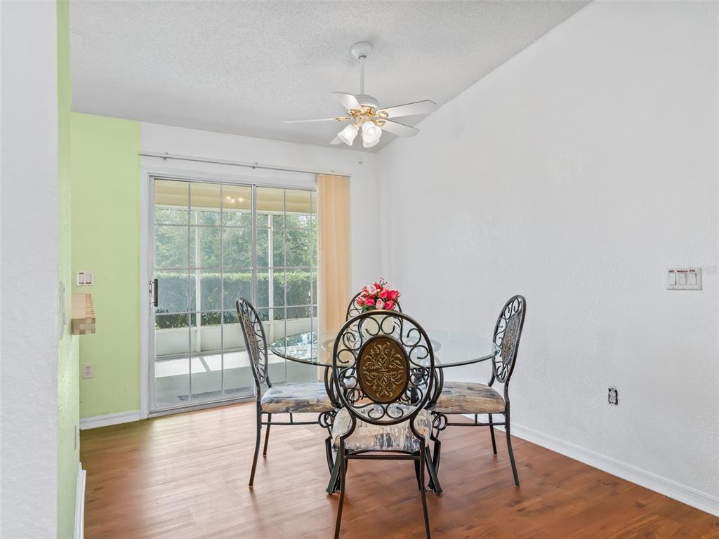 8850 Southwest 116th Place Road Ocala, FL 34481 - Photo 10 of 53 a view of a dining room with furniture wooden floor and a chandelier