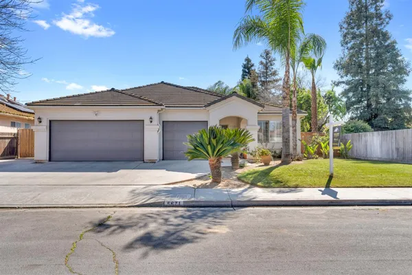 a house that has a tree in front of it