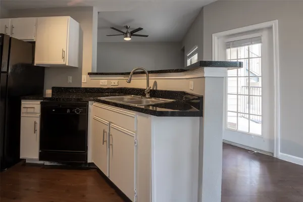 a kitchen with a sink and cabinets