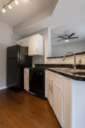 a kitchen with a sink and a refrigerator