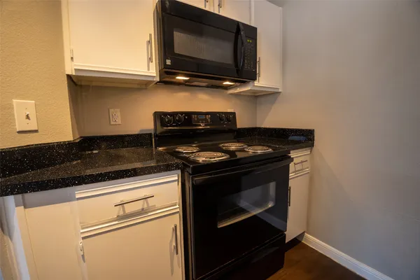 a kitchen with a stove and a microwave