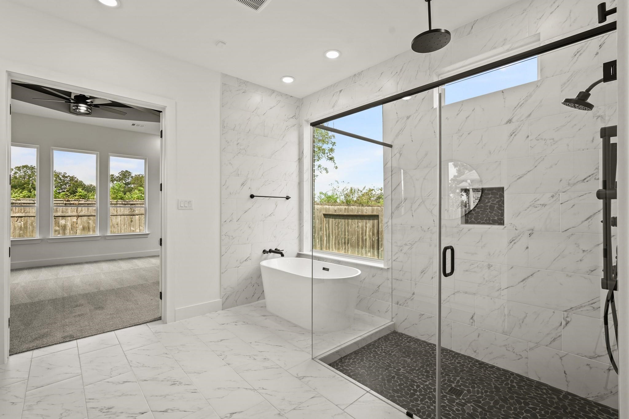 3607 Wellborn Drive Fulshear, TX 77441 - Photo 16 of 27 a spacious bathroom with a bathtub and a shower