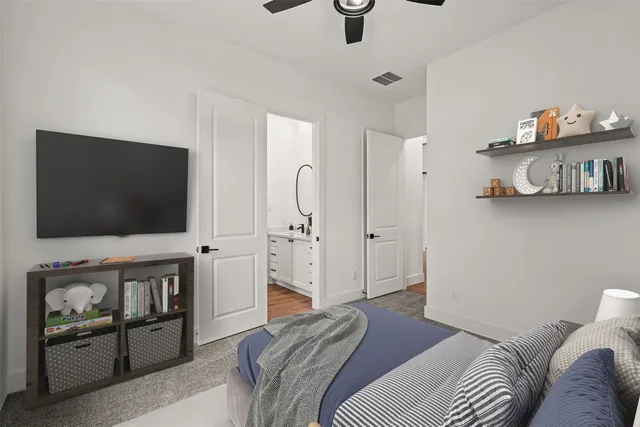 a bedroom with furniture and a flat screen tv