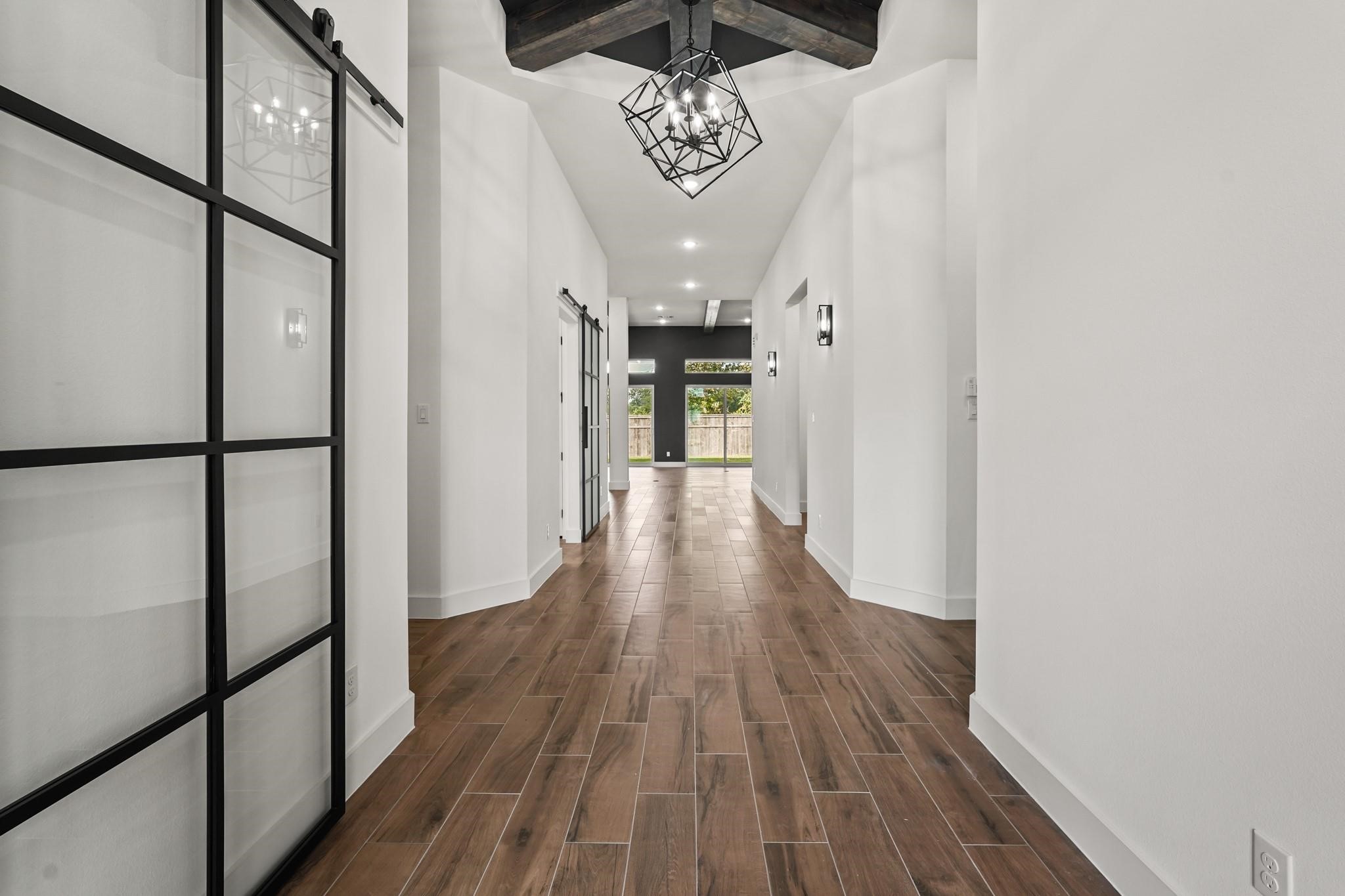 3607 Wellborn Drive Fulshear, TX 77441 - Photo 2 of 27 a view of a hallway with wooden floor