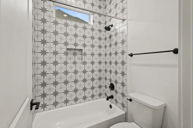 a bathroom with a bathtub and shower