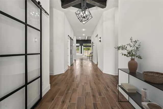 a view of a hallway with wooden floor