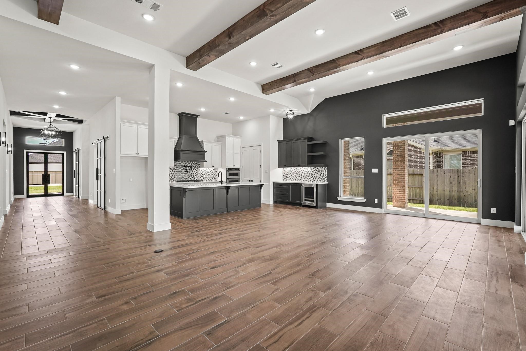 3607 Wellborn Drive Fulshear, TX 77441 - Photo 5 of 27 a view of a living room a kitchen with stainless steel appliances granite countertop a stove and a refrigerator