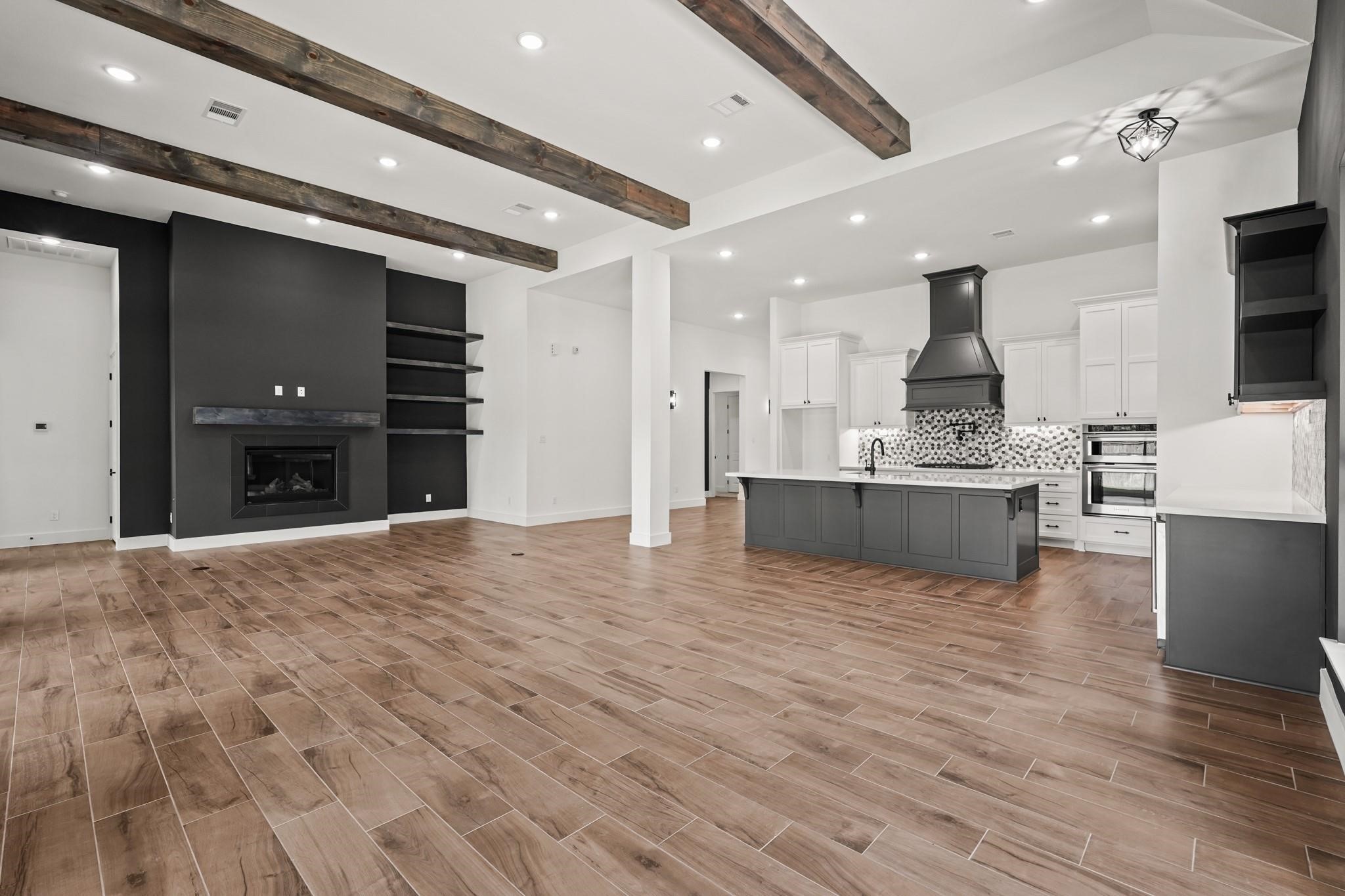 3607 Wellborn Drive Fulshear, TX 77441 - Photo 6 of 27 a large kitchen with stainless steel appliances kitchen island a large counter top and a refrigerator