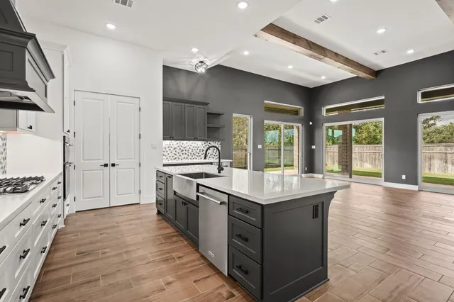 a kitchen with stainless steel appliances granite countertop a stove and a kitchen island
