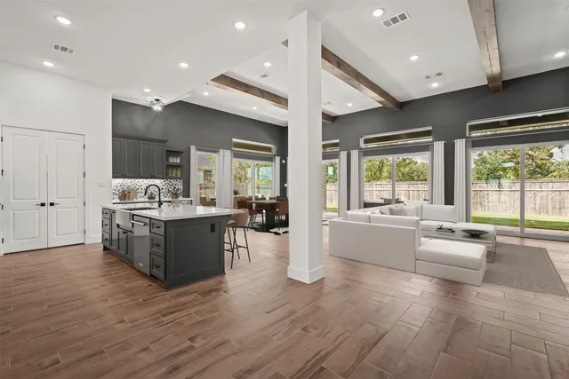 a large white kitchen with a large window