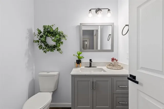 a bathroom with a toilet sink and mirror