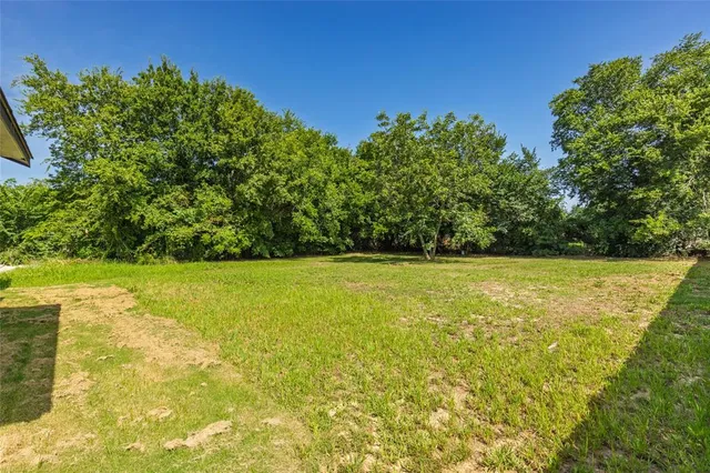 a view of yard with swimming pool and green space
