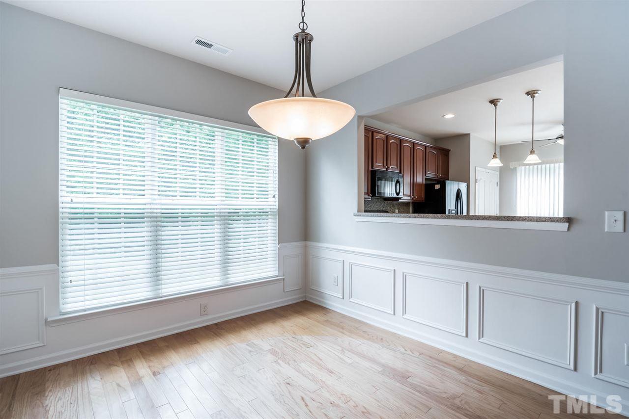 3406 Blessing House Street Raleigh, NC 27614 - Photo 4 of 23 a view of an empty room with a kitchen and a window