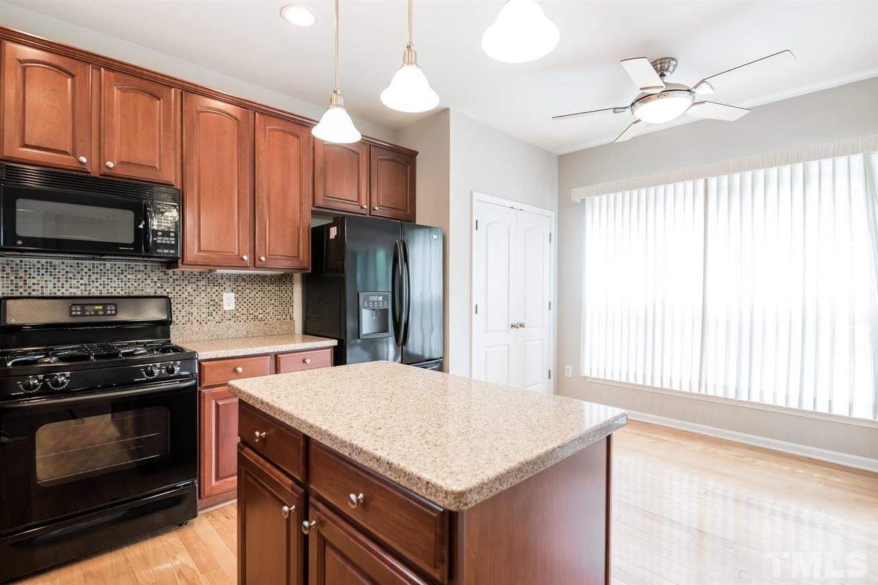 3406 Blessing House Street Raleigh, NC 27614 - Photo 8 of 23 a kitchen with a stove a sink and a microwave