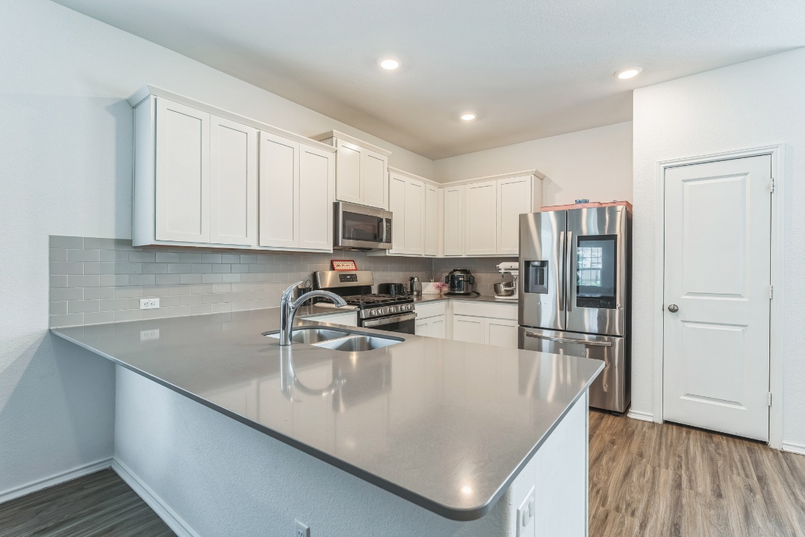 133 Cherry Ridge Road Georgetown, TX 78628 - Photo 12 of 30 a kitchen with kitchen island a counter top space cabinets and stainless steel appliances