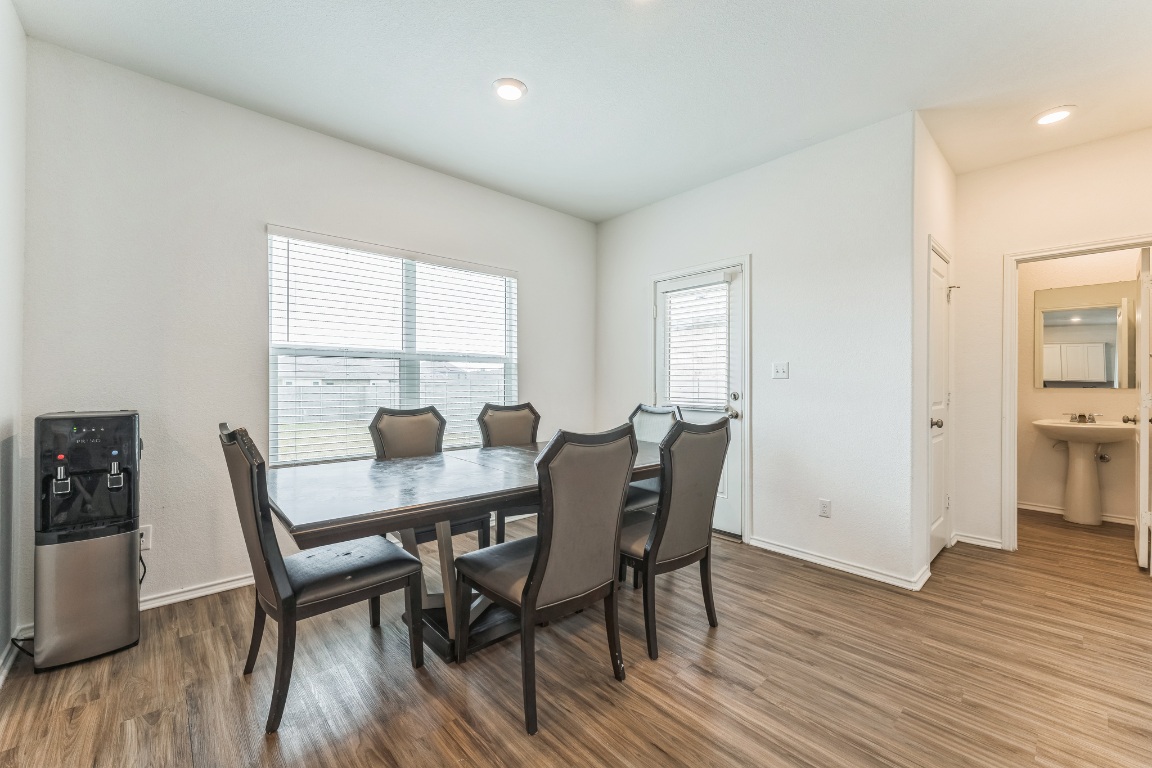133 Cherry Ridge Road Georgetown, TX 78628 - Photo 14 of 30 a view of a dining room with furniture and wooden floor