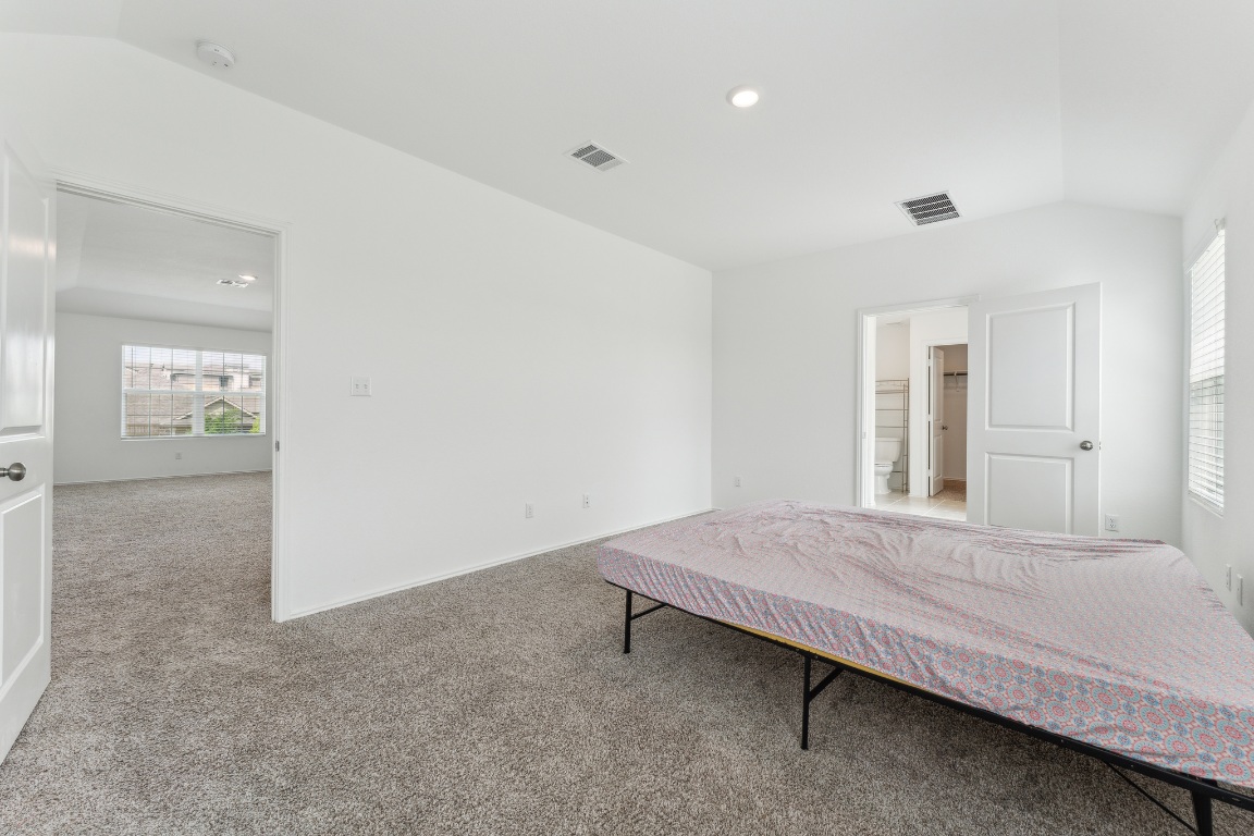 133 Cherry Ridge Road Georgetown, TX 78628 - Photo 15 of 30 a bedroom with a bed and cabinet