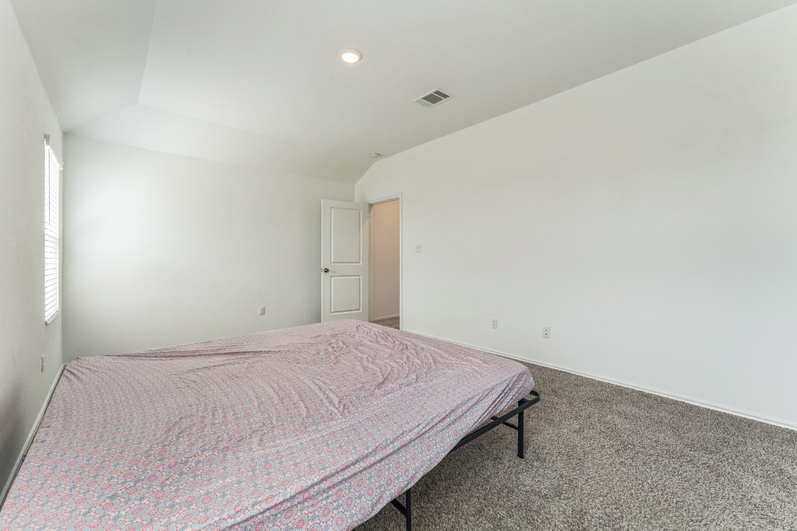 133 Cherry Ridge Road Georgetown, TX 78628 - Photo 17 of 30 a bedroom with a bed and a window