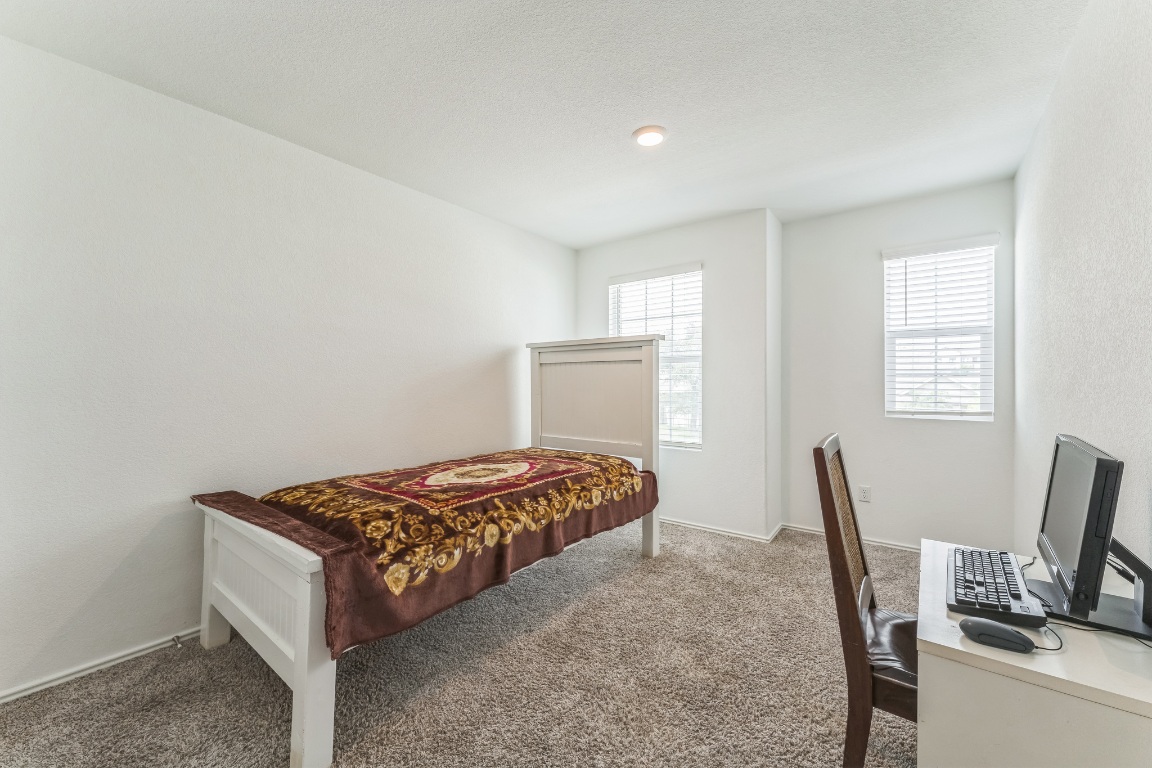 133 Cherry Ridge Road Georgetown, TX 78628 - Photo 18 of 30 a bedroom with a bed and a window
