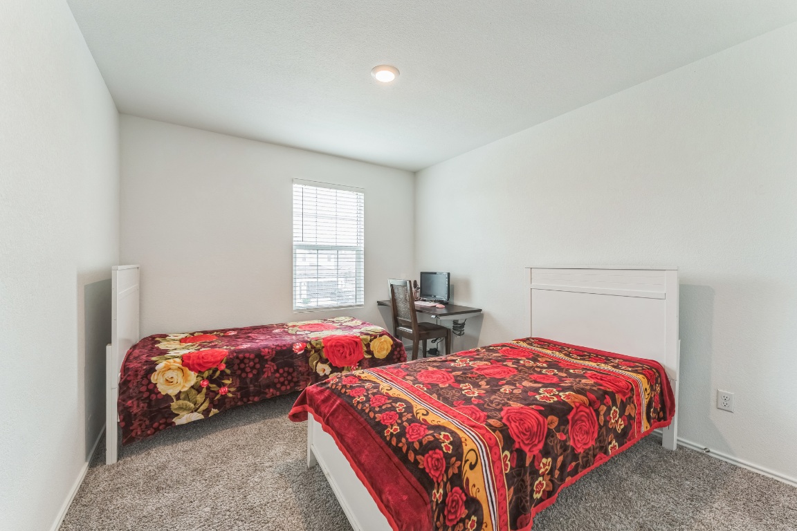 133 Cherry Ridge Road Georgetown, TX 78628 - Photo 20 of 30 a bedroom with two beds and a lamp on desk
