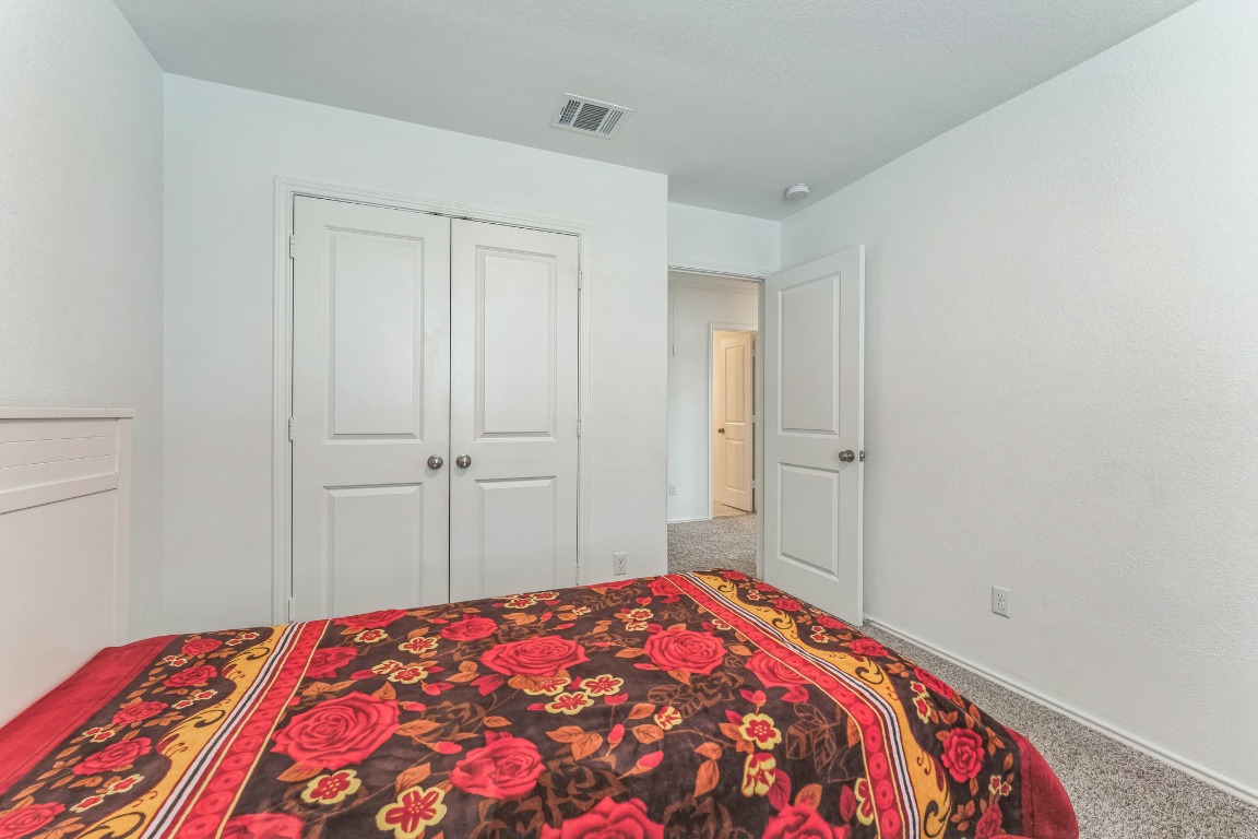 133 Cherry Ridge Road Georgetown, TX 78628 - Photo 21 of 30 a bedroom with a bed and a closet