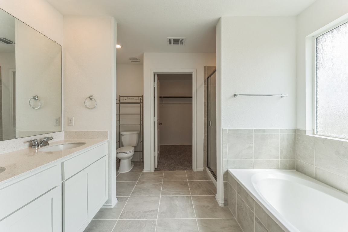 133 Cherry Ridge Road Georgetown, TX 78628 - Photo 23 of 30 a spacious bathroom with a granite countertop sink a toilet and shower