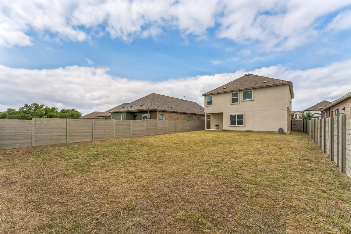 133 Cherry Ridge Road Georgetown, TX 78628 - Photo 5 of 30 a backyard of a house with lots of green space and lake view