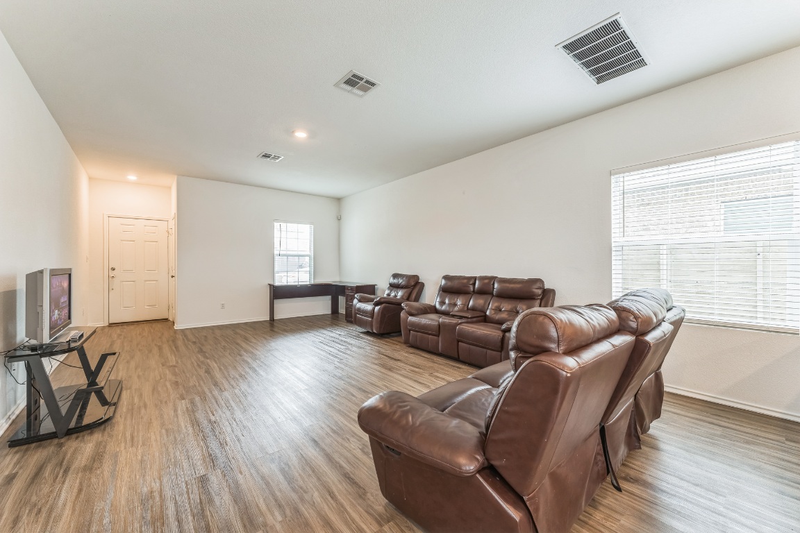 133 Cherry Ridge Road Georgetown, TX 78628 - Photo 8 of 30 a living room with furniture and a wooden floor