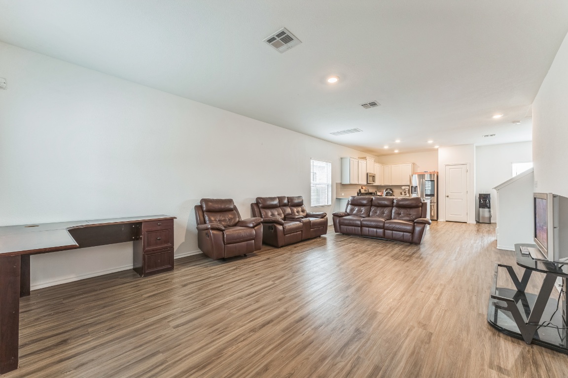 133 Cherry Ridge Road Georgetown, TX 78628 - Photo 9 of 30 a living room with furniture and a wooden floor