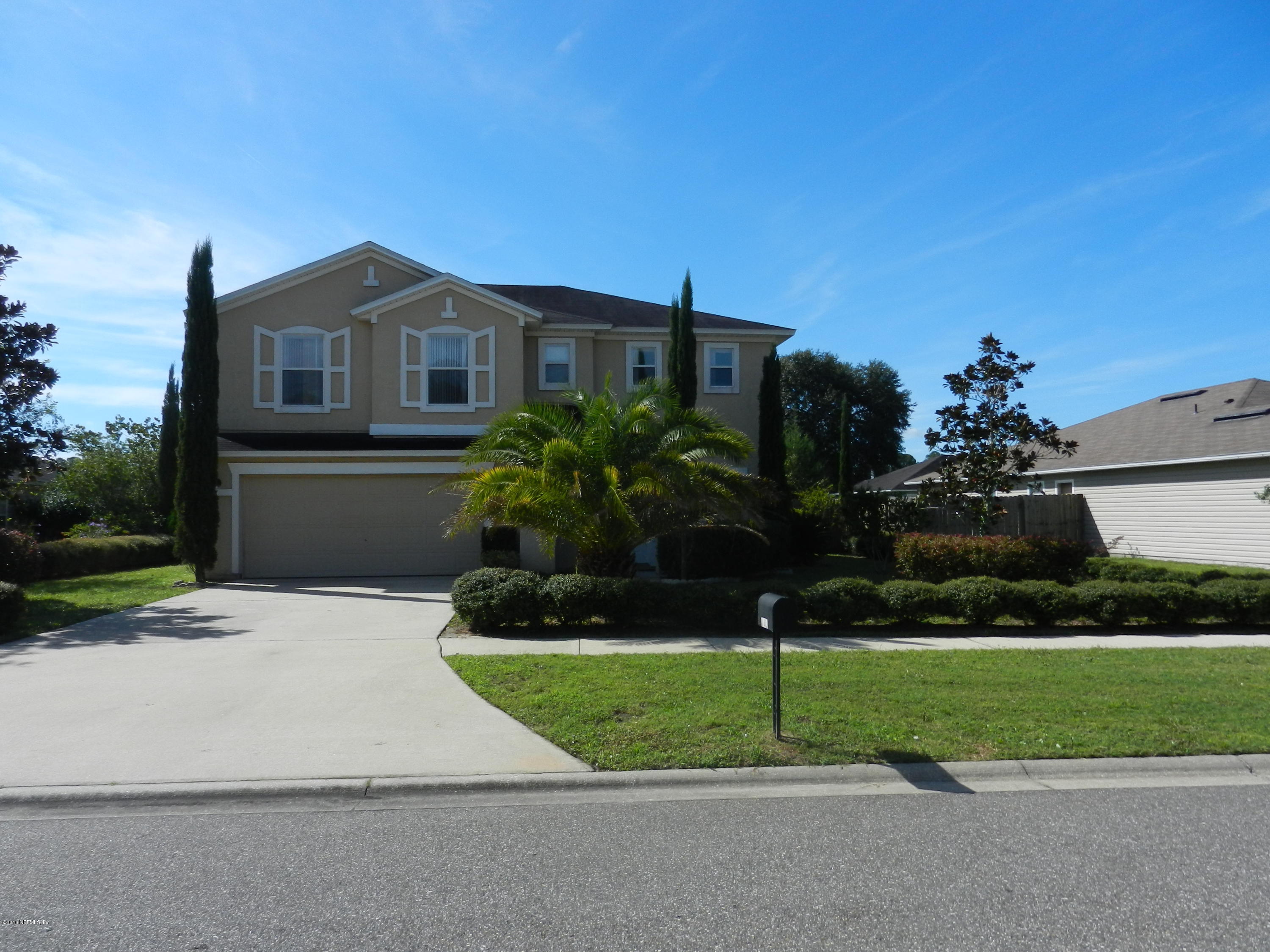 86339 Cartesian Pointe Drive Yulee, FL 32097 - Photo 14 of 21 a front view of a house with a yard and garage