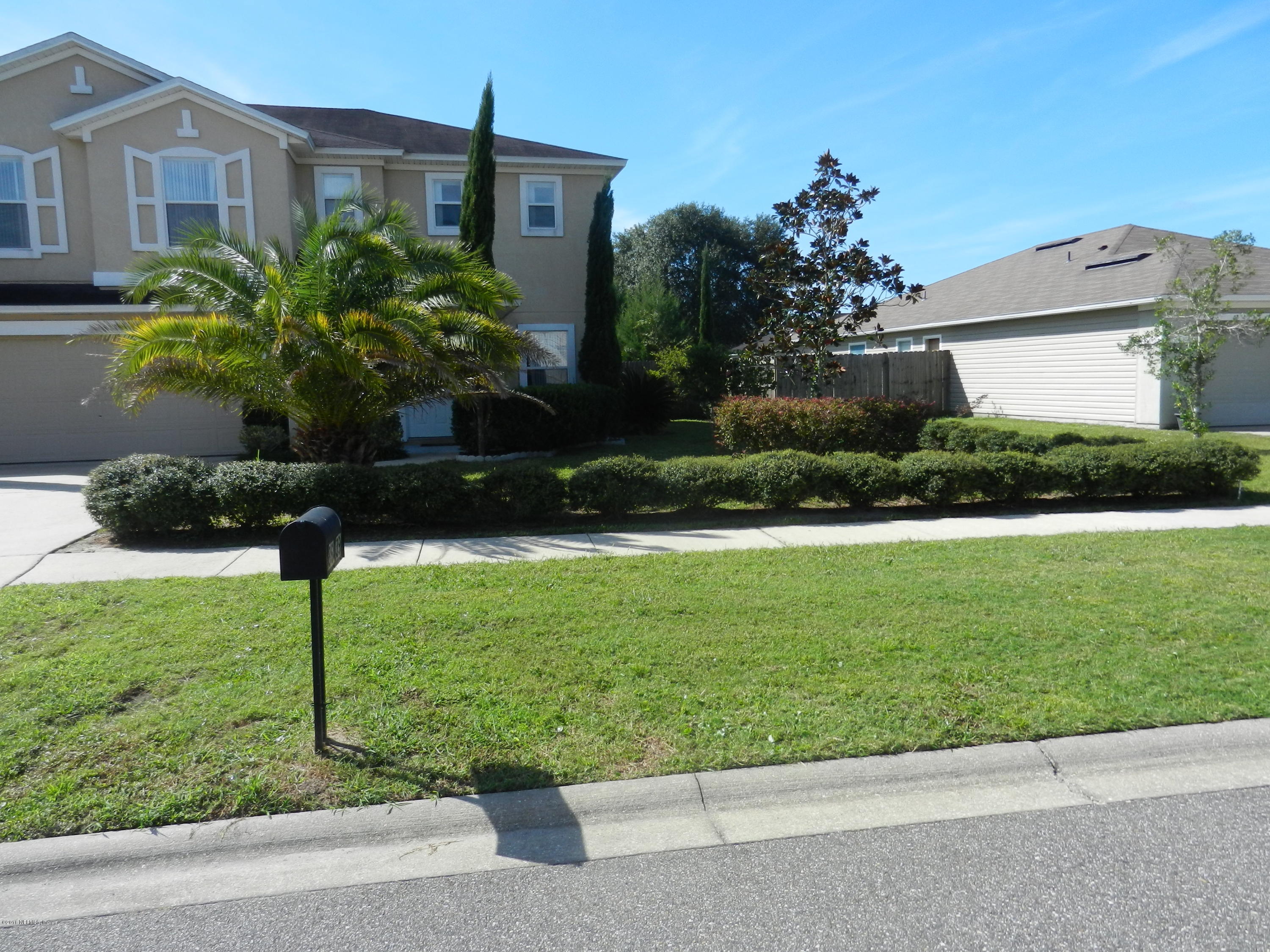 86339 Cartesian Pointe Drive Yulee, FL 32097 - Photo 15 of 21 a front view of a house with garden