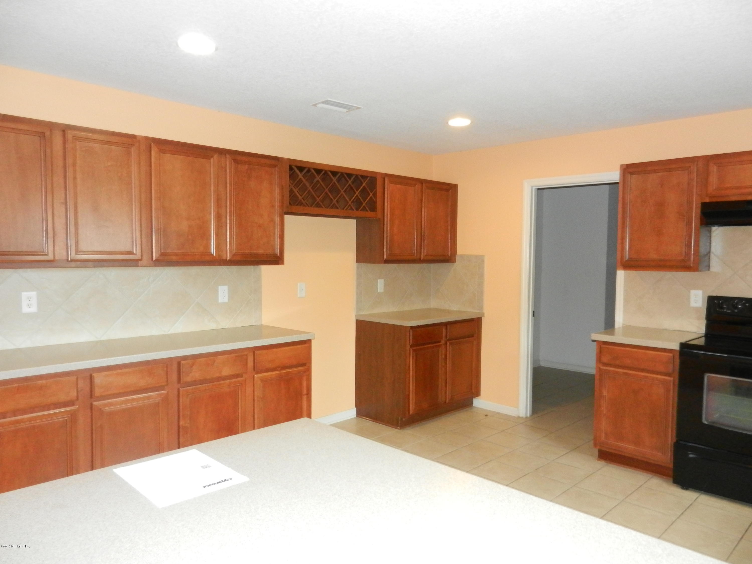 86339 Cartesian Pointe Drive Yulee, FL 32097 - Photo 3 of 21 a kitchen with stainless steel appliances a refrigerator sink and cabinets