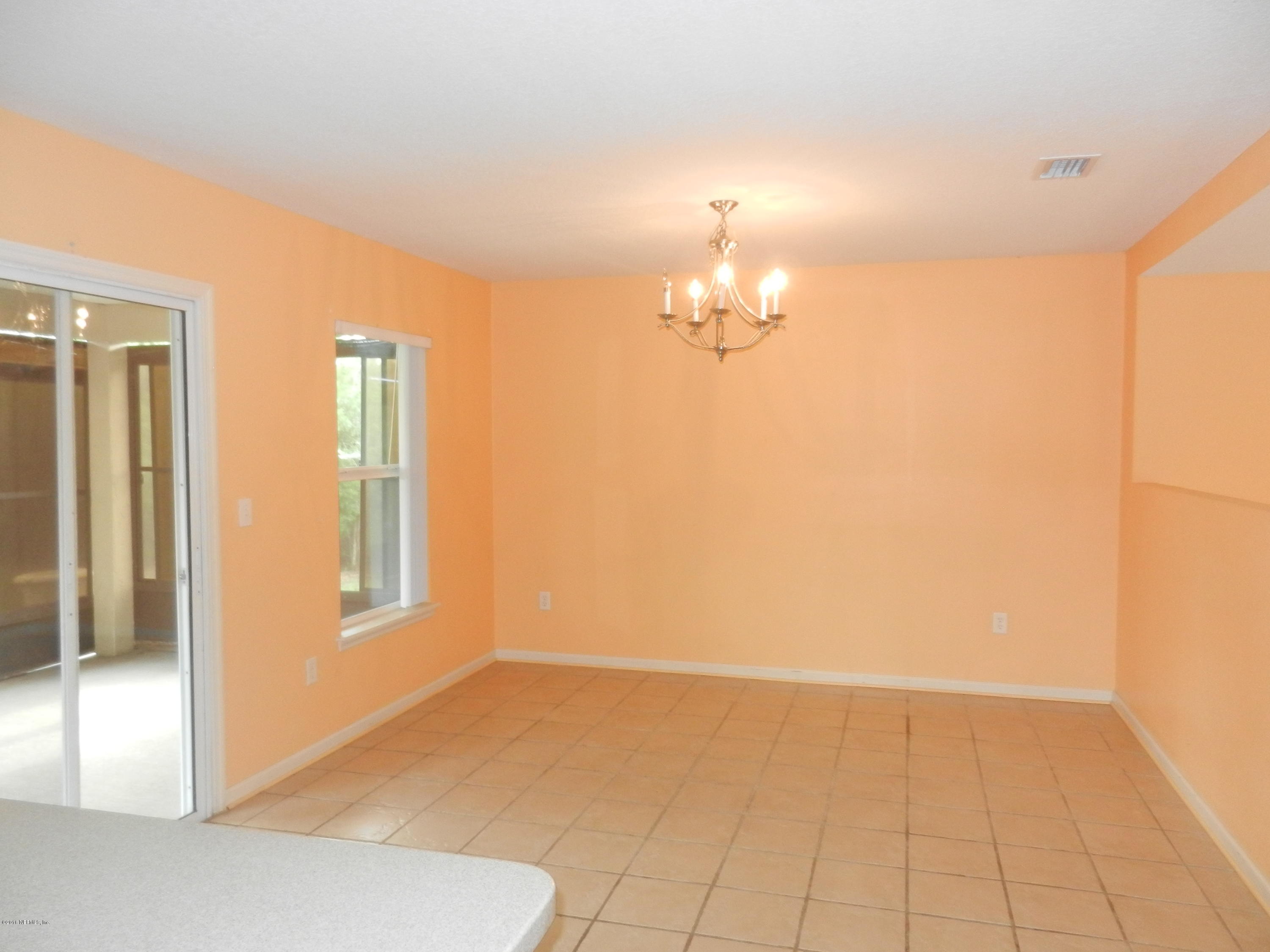 86339 Cartesian Pointe Drive Yulee, FL 32097 - Photo 4 of 21 an empty room with chandelier fan
