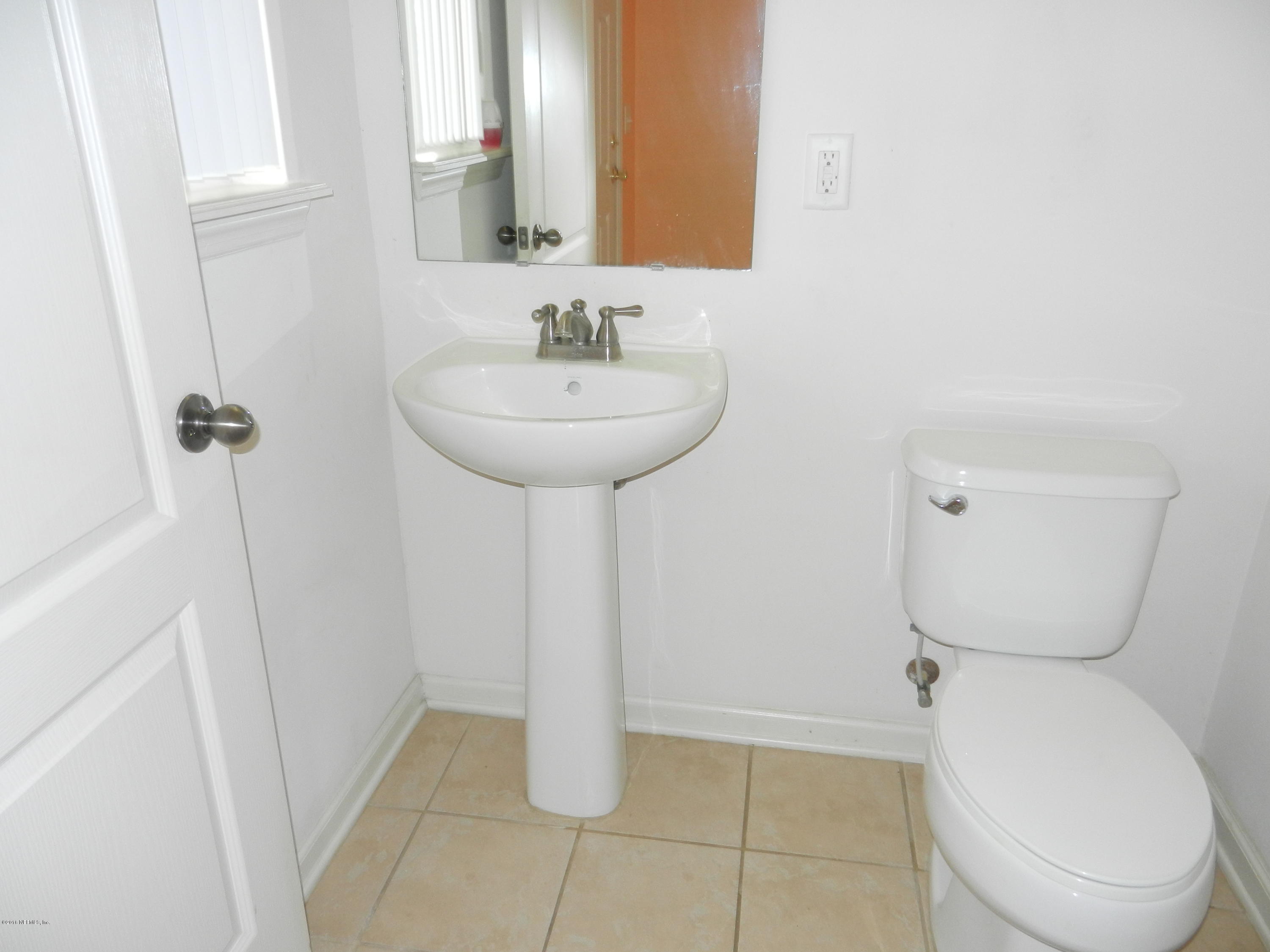 86339 Cartesian Pointe Drive Yulee, FL 32097 - Photo 5 of 21 a bathroom with a toilet sink and mirror