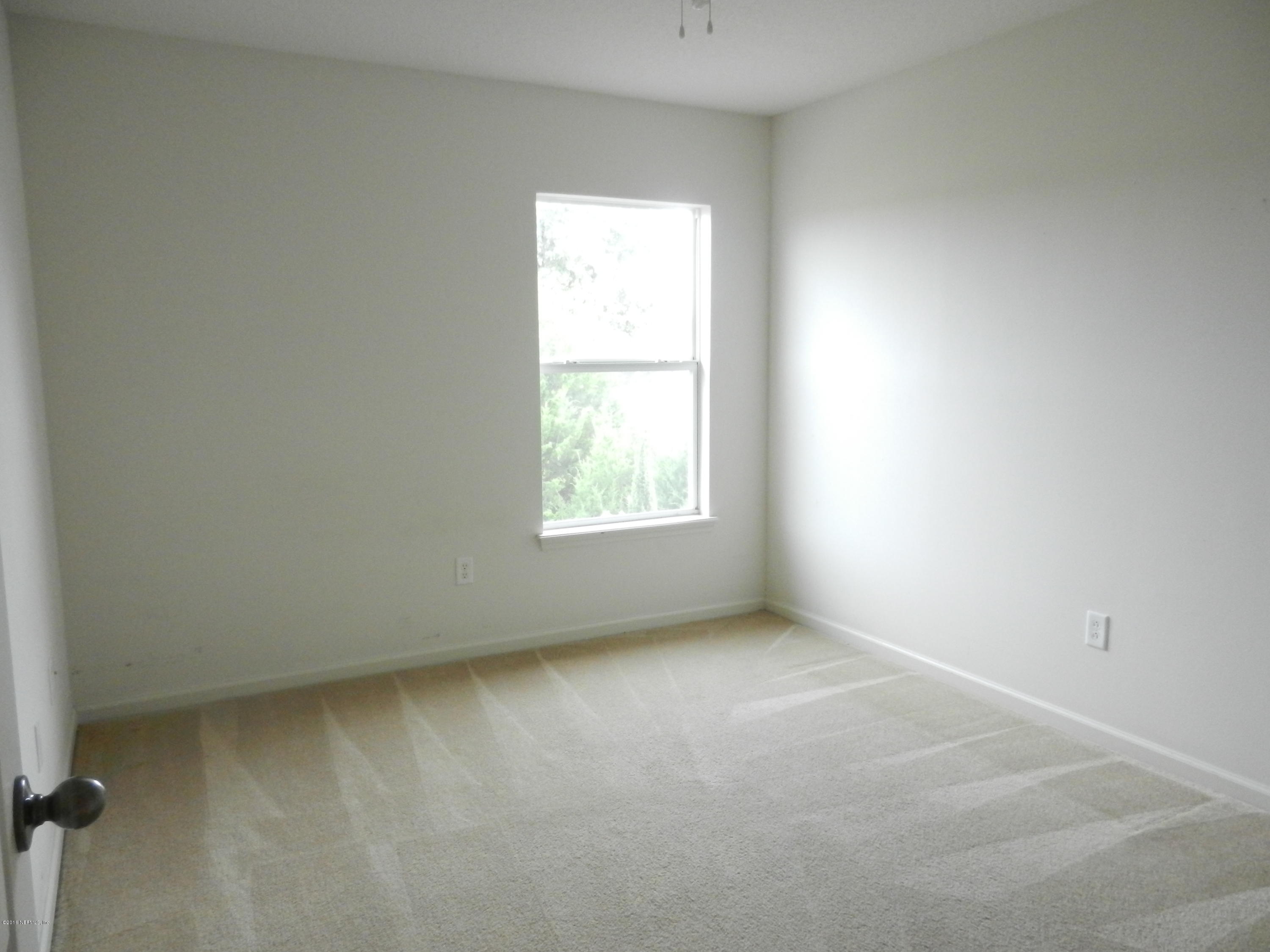 86339 Cartesian Pointe Drive Yulee, FL 32097 - Photo 8 of 21 an empty room with a window
