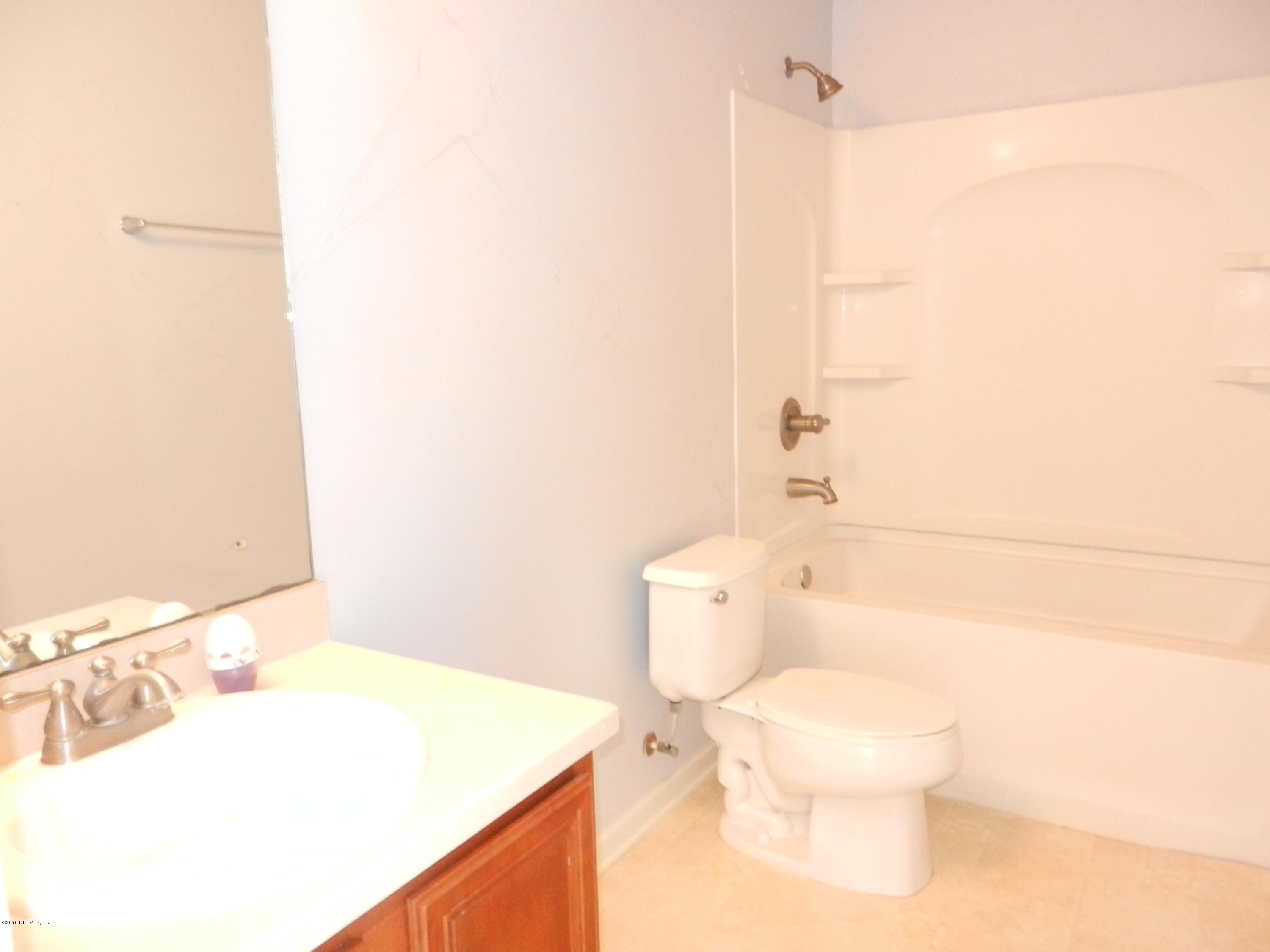 86339 Cartesian Pointe Drive Yulee, FL 32097 - Photo 9 of 21 a bathroom with a sink a toilet and shower