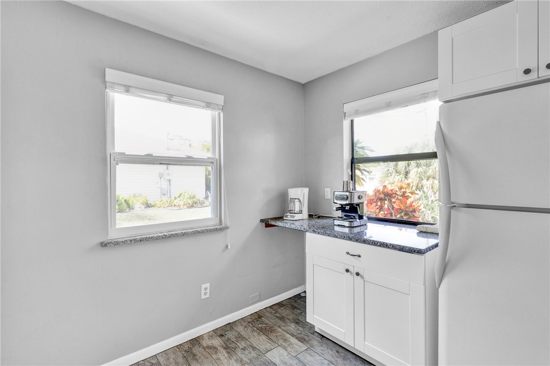 202 Delaware Avenue Sebastian, FL 32958 - Photo 11 of 34 a kitchen with white cabinets and a window
