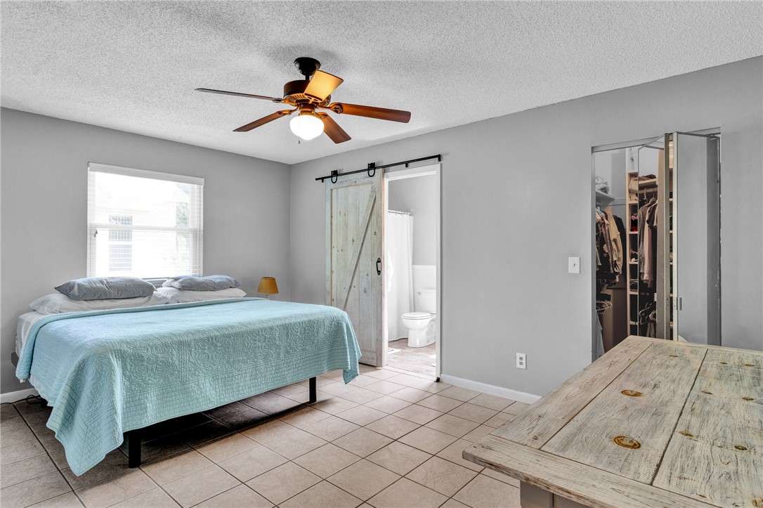 202 Delaware Avenue Sebastian, FL 32958 - Photo 13 of 34 a bedroom with a bed and a chandelier