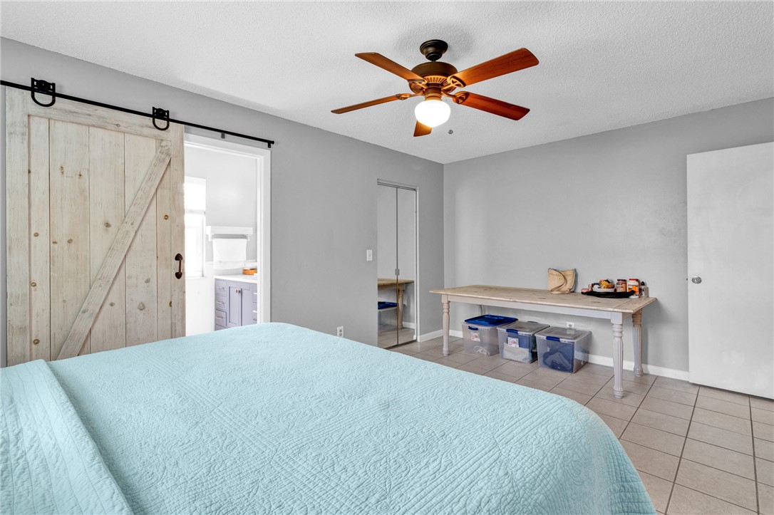 202 Delaware Avenue Sebastian, FL 32958 - Photo 14 of 34 a bed room with a bed and a chandelier
