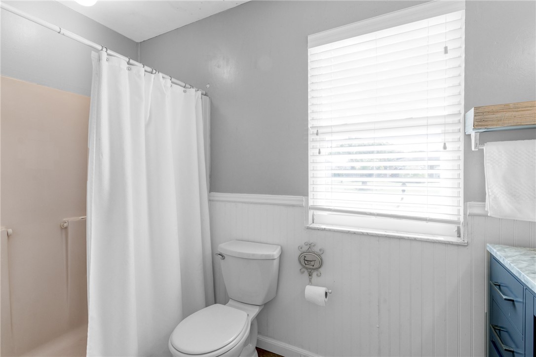 202 Delaware Avenue Sebastian, FL 32958 - Photo 16 of 34 a white toilet sitting next to a window in a bathroom