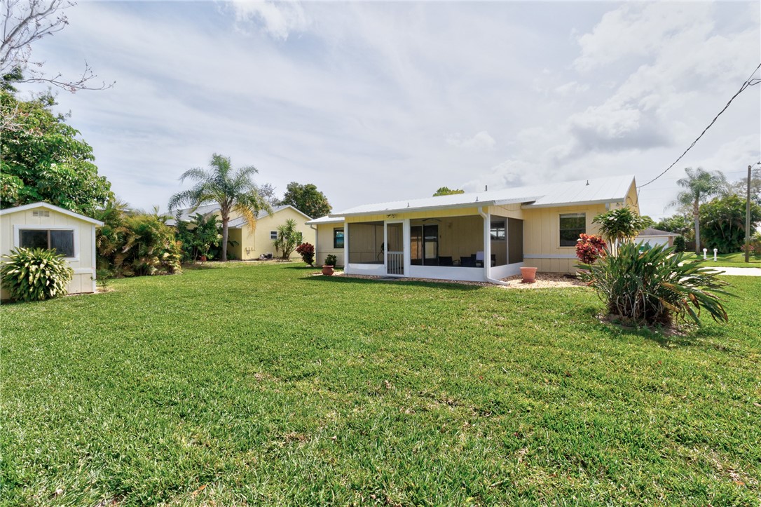 202 Delaware Avenue Sebastian, FL 32958 - Photo 24 of 34 a view of a house with a backyard porch and sitting area