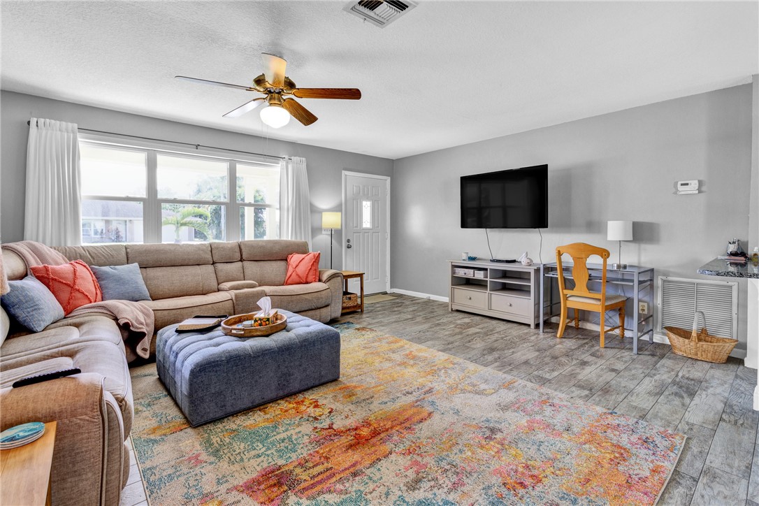 202 Delaware Avenue Sebastian, FL 32958 - Photo 5 of 34 a living room with furniture a flat screen tv and a window