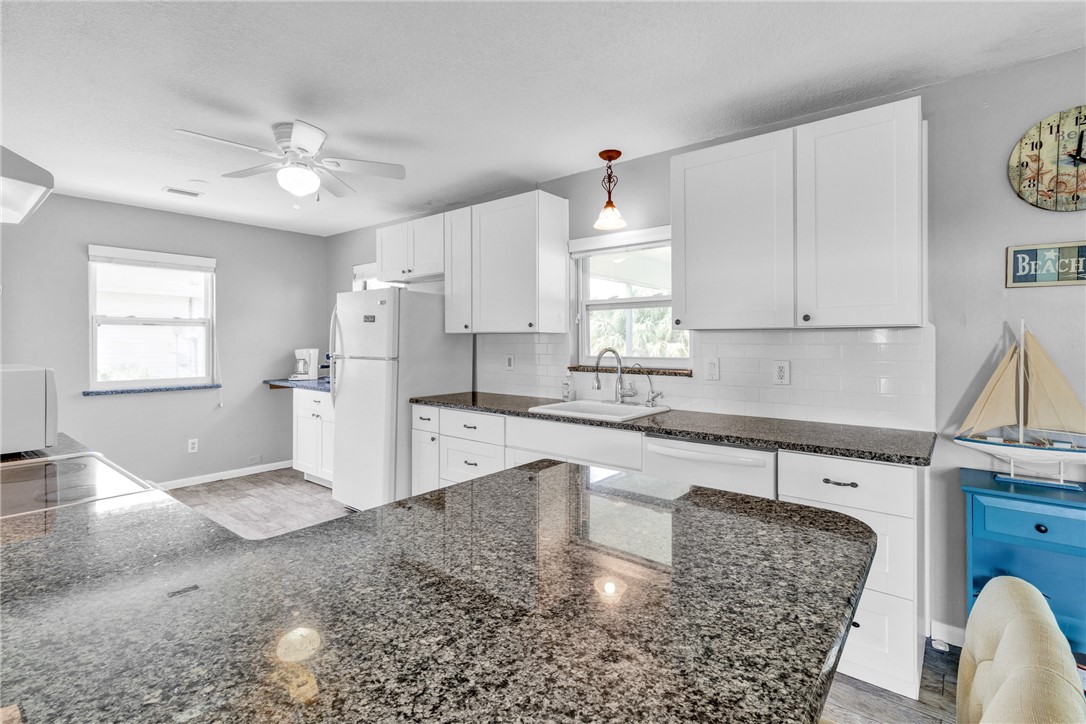 202 Delaware Avenue Sebastian, FL 32958 - Photo 9 of 34 a kitchen with stainless steel appliances granite countertop a sink stove and cabinets