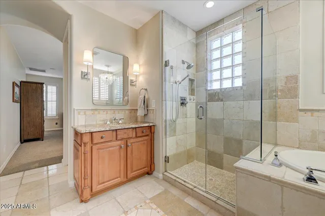 a spacious bathroom with a shower sink and mirror