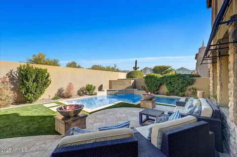 a view of roof deck with couches and potted plants