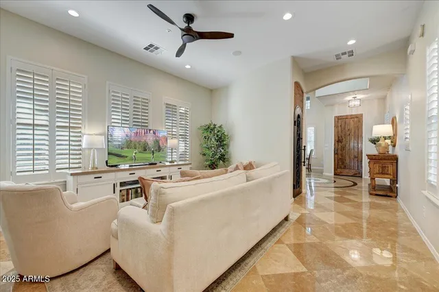 a living room with furniture and large windows