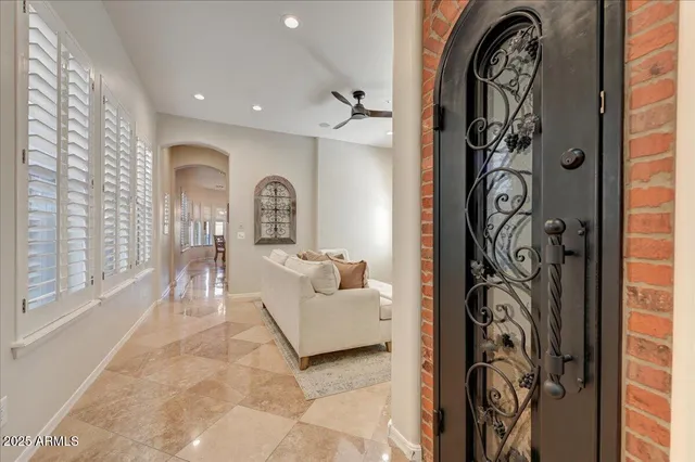 a living room with furniture and a painting on the wall